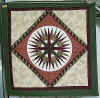 http://amishshop.com/hazel-doc/imageamish2008/wallquiltmarinerscompassgrn.jpg (164067 bytes)